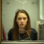 Placeholder: A blurred woman behind a broken bathroom glass