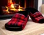 Placeholder: Red plaid slippers, black fur rug,log cabin fireplace