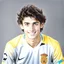 Placeholder: 85mm DSLR color photography of a very detailed headshot fitting all of head and hair in frame. 19-year-old Spanish soccer player, and with no facial hair and has no facial hair, has short and black hair with a small smile, grey background his from catalan