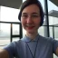 Placeholder: A short haired, female computer engineer taking a selfie in front of Building 92 at Microsoft