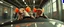 Placeholder: car driving happy 2d neon fluffy orc racer rats with human hands in the style of Escher and Giger and Fallout 4, pinhole cam, airbrush 3d rendering, on tv screen:A five-second cinematic single take in a clean industrial presentation hall.