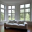 Placeholder: Living room with a big double window, white Beaux Arts architecture,interior design,point of perspective