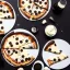 Placeholder: pizza with white chocolate, black chocolate, napkins, black table