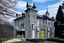 Placeholder: A gray Scottish chateau made out of steel painted by Roy Lichtenstein