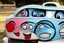 Placeholder: whimsical cartoon car with big eyes and its front grill forming a friendly smile