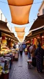 Placeholder: a view of a public market in Morocco showing people sailing food and outlet requirements