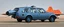 Placeholder: A national geographic award winning photograph of a military fighter jet station wagon wasp hybrid designed by volkswagen only one vehicle per image painted metallic orange traveling at a high rate of speed, jet intake off of front center of vehicle and jet exhaust out the rear with bright blue flame