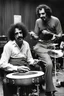 Placeholder: Frank zappa playing bongos next to a very fat black man