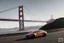 Placeholder: A Tesla 'Model Y' is racing at top speed, on the 'Golden Gate' bridge. (CINEMATIC, WIDE ANGLE LENS, PHOTO REAL)