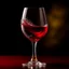 Placeholder: Create an artistic representation of a wine glass with a rich, red wine pouring gracefully into it. Capture the moment when the wine is suspended in mid-air, forming a beautiful arc as it enters the glass. The background should have soft, warm lighting to accentuate the colors and enhance the overall feeling of elegance and indulgence.