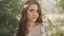 Placeholder: Beautiful caucasian 19 year old girl with light brown hair. She is wearing a silk floral blouse. She is smiling shyly at the viewer.