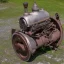 Placeholder: Single cylinder engine, rusty, old, small, simple