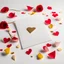 Placeholder: A photo of a white card, 5.5 by 4.25 inches. The card is vertically positioned on a beautiful white surface, positioned between rose petals and litte golden hearts.