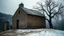 Placeholder: a lonely old adobe hut with worn adobe brown-gray wall and a small window, a crumbling roof, an old chimney stands on a hill, next to it is a small woodshed by the wall, and an old withered tree leans over the hut, the hut stands on the edge of a European forest, winter, snowy landscape, low light, dawn, high detailed, sharp focus, high realistic, perfect photo