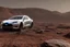 Placeholder: A Tesla 'Model S' is parked, at the Cydonia region on Mars. (CINEMATIC, WIDE ANGLE LENS, PHOTO REAL)