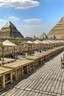 Placeholder: A tourist walkway in Egypt overlooking the pyramids and has seating places, and shops on both sides