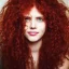 Placeholder: Woman with red curly hair and brown eyes