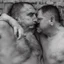 Placeholder: realistic, two italian prisoners 44 years old kissing in prison behind bars, dirty, ugly, bullneck, muscular chubby, in tank top, long hairs, manly chest, misery and poverty, emotive eyes, photo 50mm lens, side view, photorealistic, ultradetailed