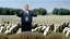 Placeholder: George w bush at podium speaking to large field of sheep