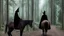 Placeholder: Dark robed wizard on a horse in the forest