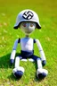 Placeholder: plush toy(tall and skinny, no arms, no legs, 1 eye) sitting, wearing a Nazi helmet, small feet at front, in a field of short grass