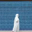 Placeholder: woman in flowing, white burka walking in front of a mosque with blue, green, gold mosaic walls, profile, panoramic, high-quality, fine-detail, intricate, ornate, volumetric lighting, 8k resolution, haunting, powerful, photo-realistic, 3d render, photo-quality, National Geographic photograph, Life magazine photograph