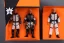 Placeholder: Mike pence G.i. Joe toy doll space force uniform inside a blister package hanging on A rack in toystore, fluorescent orange, wide angle shot whole body, black moonboots, fullsize