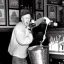 Placeholder: William Luby pouring a bucket full of beer on his own head at a pub