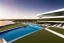 Placeholder: Sunset algarve in quinta do lago, one straight line building of 250 meters long pool of a modern luxury architecture with wood and gold metallic pergolas with pool on rooftop, green roofs and sun loungers next to pool, overlooking a tennis and padel sport facility, on a slope with pinus pinea, a road wrap around for low speed veicular road