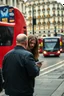 Placeholder: A stalker wants an autograph from a long-haired rock musician on a street in central London. The stalker is an overweight soon bald 25-year-old and looks a bit slimy, the atmosphere is oppressive and unpleasant, lot of traffic and london busses, hectic hour, a nice hotel