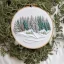 Placeholder: exquisite whimsical snowy forest in embroidery hoop, intricate, highly detailed, linen and wood backdrop