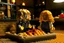 Placeholder: blonde lego girl and curly black haired lego boy eating lego pizza in an italian restaurant in candlelight