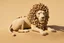 Placeholder: lion made of pebbles in sand