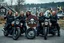 Placeholder: a very hard and tuff motorcycle young gang with Keltic hair , not old, posing with their Harley Davidsson bikes, some of them holding guns and shotguns, a logo sign with "FALKÖPING HD", "FEARLESS SINNERS" Skulls and bones, skeletons and fire, Swedish town Falköping in background, Swedish flags on bikes, Simon Stålenhag style