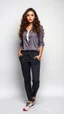 Placeholder: beautiful lady with makeup in pants and pretty shirt curvy long hair sport shoes standing relaxed posing to camera simple empty studio background