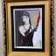 Placeholder: framed Portrait of Nina Dominic, also known as Tammy Gun, is a wise woman and member of the Celestial Order of Hathor in the 1920s nina is beautiful and powerful in Neo-Expressionism art movement style