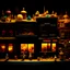 Placeholder: Close-up photograph of a diorama building, city, store, advertising, land-of-toys with detailed vintage toys made of cake-frosting and felt, strong texture, extreme detailed, movie shot, rich moody colors, sparkles, night, nightmare