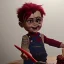 Placeholder: create me an ultra realistic chucky doll celebrating his 35th birthday by stabbing the cake with his knife