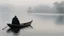 Placeholder: black robed monk in a small boat on quiet water in the mist