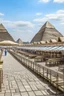 Placeholder: A tourist walkway in Egypt overlooking the pyramids and has seating places, and shops on both sides