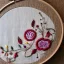 Placeholder: exquisite whimsical in embroidery hoop, intricate, highly detailed, linen and wood backdrop