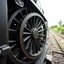 Placeholder: straight on view of spoked steel wheel from a steam train. just the wheel