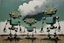 Placeholder: (three:2) determined whimsical robots (made of scrap metal:2) dancing in a scrapyard under stormy sky, acrylic painting, minimal art, centered, wild sparse brushstrokes, amazing verticals, great parallels, low bleak colors of green, drab, beige and black, excellent negative space contrasts