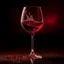 Placeholder: Create an artistic representation of a wine glass with a rich, red wine pouring gracefully into it. Capture the moment when the wine is suspended in mid-air, forming a beautiful arc as it enters the glass. The background should have soft, warm lighting to accentuate the colors and enhance the overall feeling of elegance and indulgence.