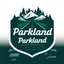 Placeholder: logo for a shop that installs tires and does oil changes, top has elements of beautiful park highway drive, bottom shows the engine under car hood. on windshield is written "Parkland", all inside a shield shape with squared top and rounded bottom, in the style of national parks stickers