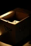 Placeholder: The fingertips of a clawed hand emerging from the top flaps of a cardboard box, the word "surprise" handwritten on the front surface. The box is in a darkened storeroom with a single light source from an ajar door.