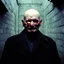 Placeholder: very grainy discolored photo, portrait, dark sewer, grunge, 2000s Russia, punk, outcast, rough, confident, bald older male wearing a coat, extremely pale skin, large flesh bulbs grow out of his face and covering a lot of it, face is disproportionally deformed, hunchback, sewer dweller