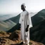 Placeholder: African man in white thobe, standing on top of mountain