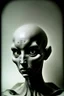 Placeholder: Black and white high brow photograph of a grey alien, film analog, dust overlay, eerie, high strangeness, surrealistic old photograph, mysterious,