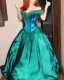 Placeholder: princess with long auburn hair in a big teal green and gold satin ballgown corset off shoulder top casting magic